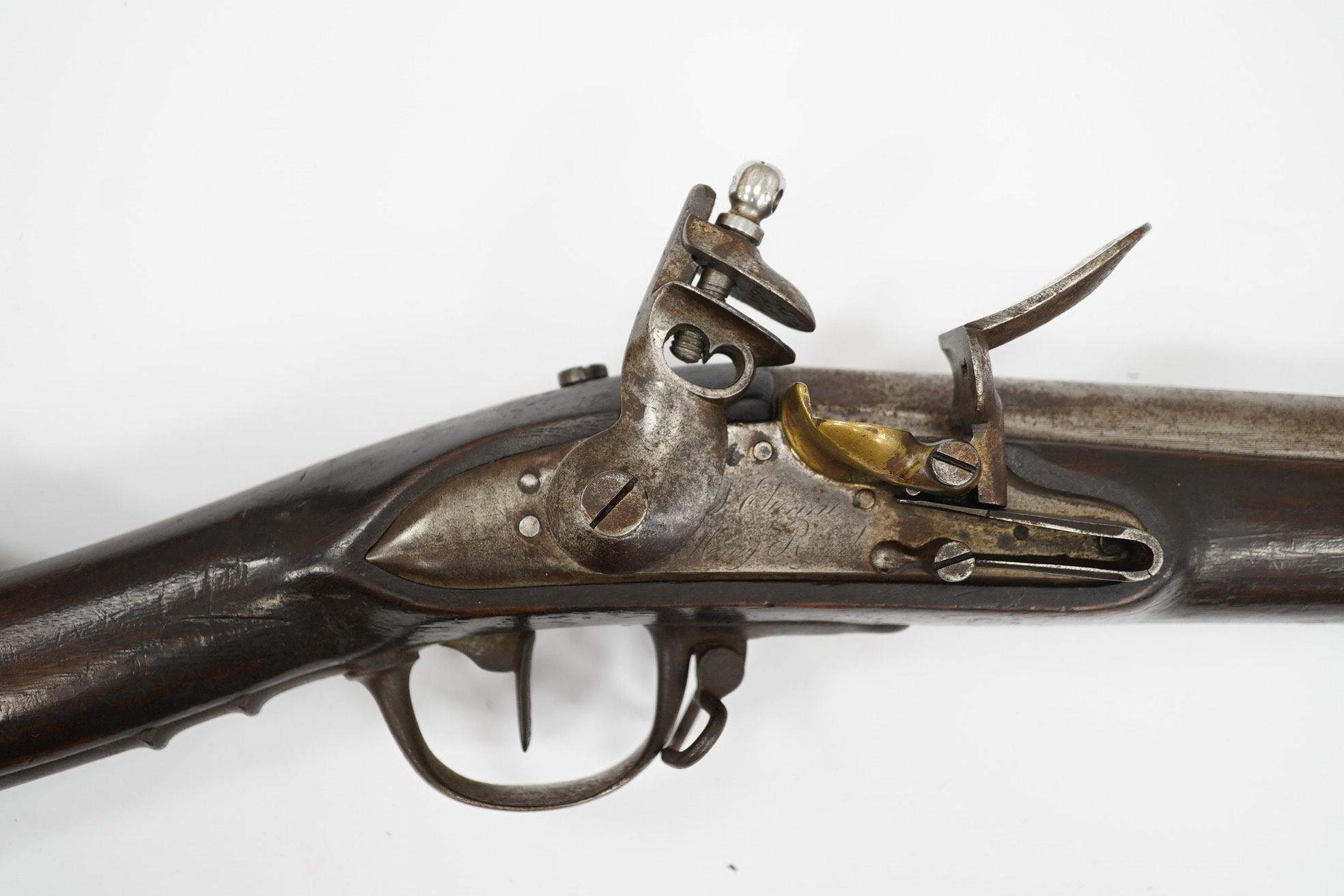 An 18mm French military flintlock musket, lock engraved St. Etienne Manufre Royale, regulation lock with brass pan, iron barrel and regulation iron mounts, with steel rammer. Condition - fair